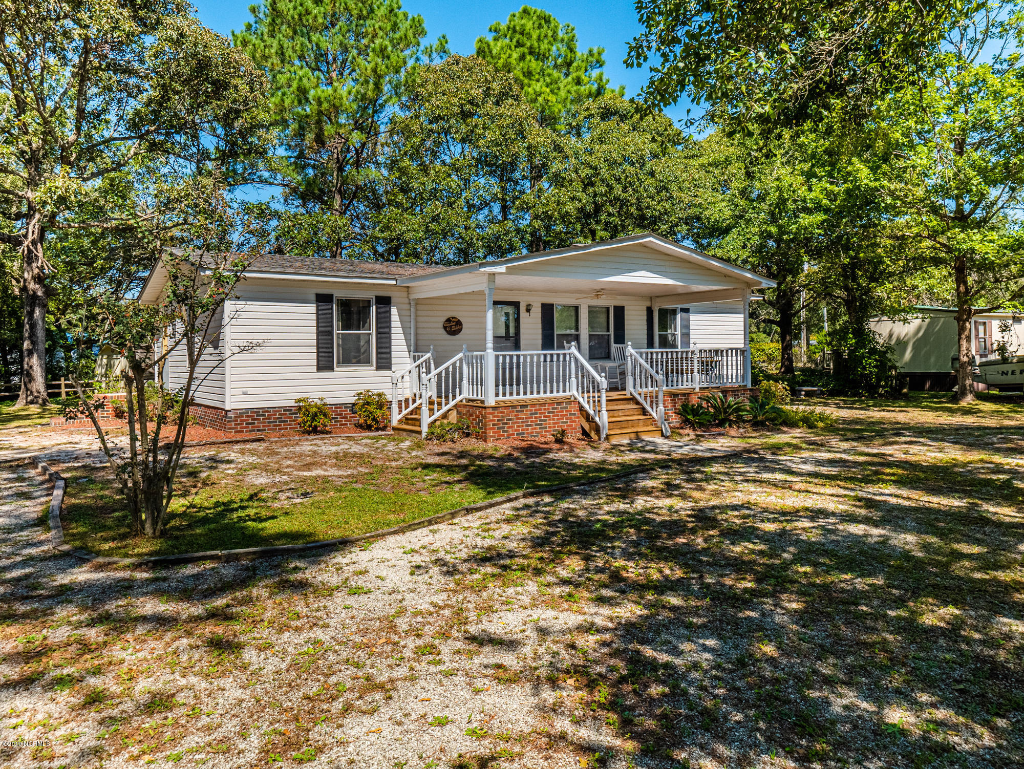 211 Doe Ridge Road Hampstead, NC 28443 - Photo 25 of 27 Side angle view of the Front of home with driveway