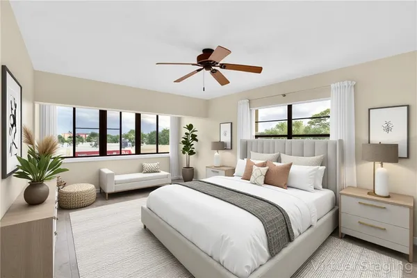 a bedroom with a large bed and a chandelier