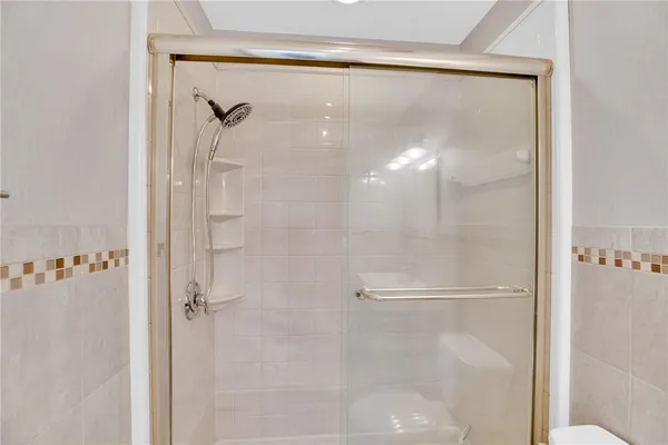 a bathroom with a glass shower door