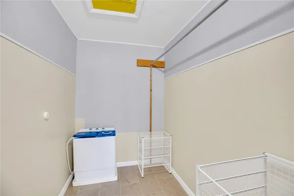 a view of storage and utility room with wooden floor