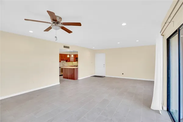 a view of a livingroom with a ceiling fan and window