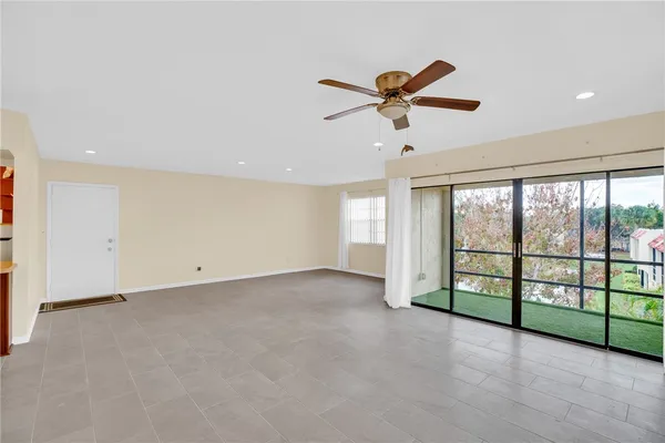 a view of a livingroom with a ceiling fan and window