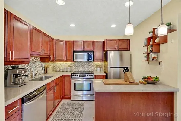 a kitchen with stainless steel appliances granite countertop a sink stove and refrigerator