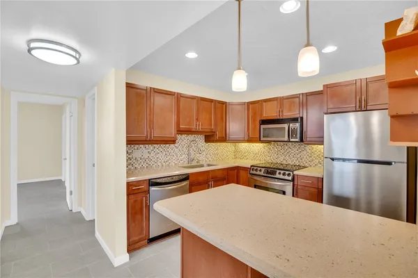 a kitchen with a refrigerator a sink and a stove