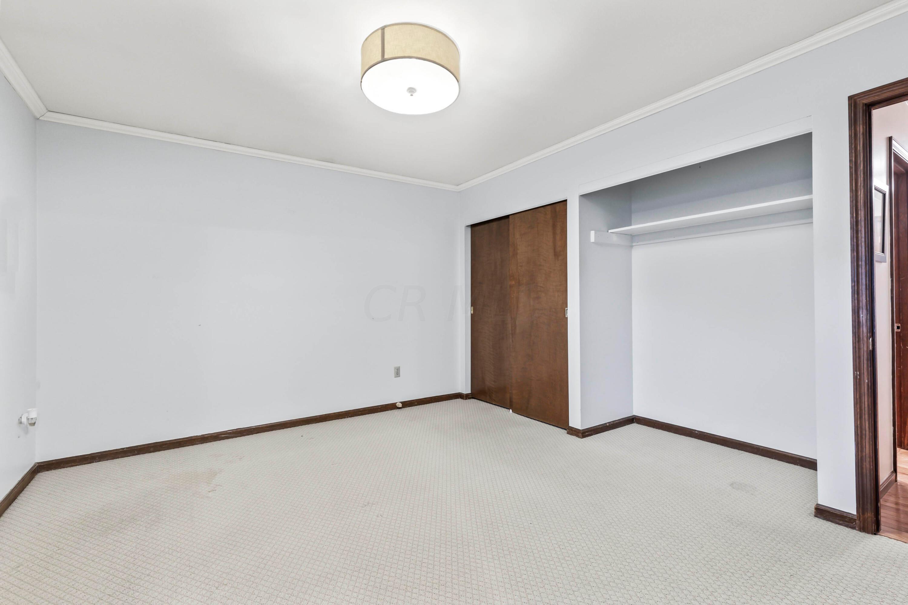 7020 Rieber Street Columbus, OH 43085 - Photo 24 of 40 • Berber carpet • Grey painted walls • New ceiling light ~ 2017 • Crown molding • Two lighted closets with double sliding doors • TV & mount are negotiable