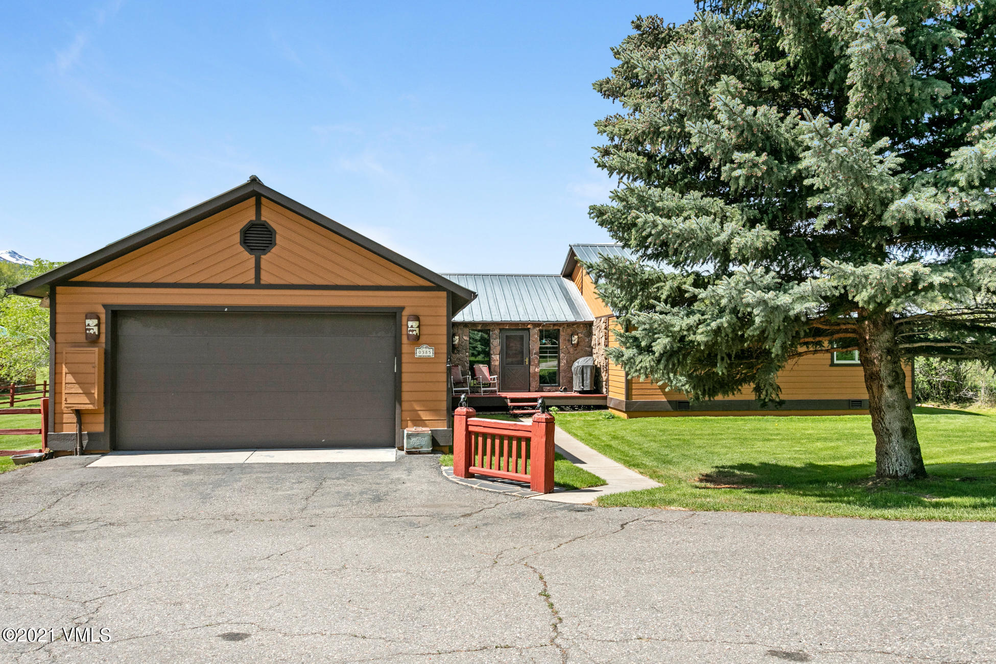 385 Edwards Access Road Edwards, CO 81632 - Photo 21 of 37 a front view of a house with a yard and garage