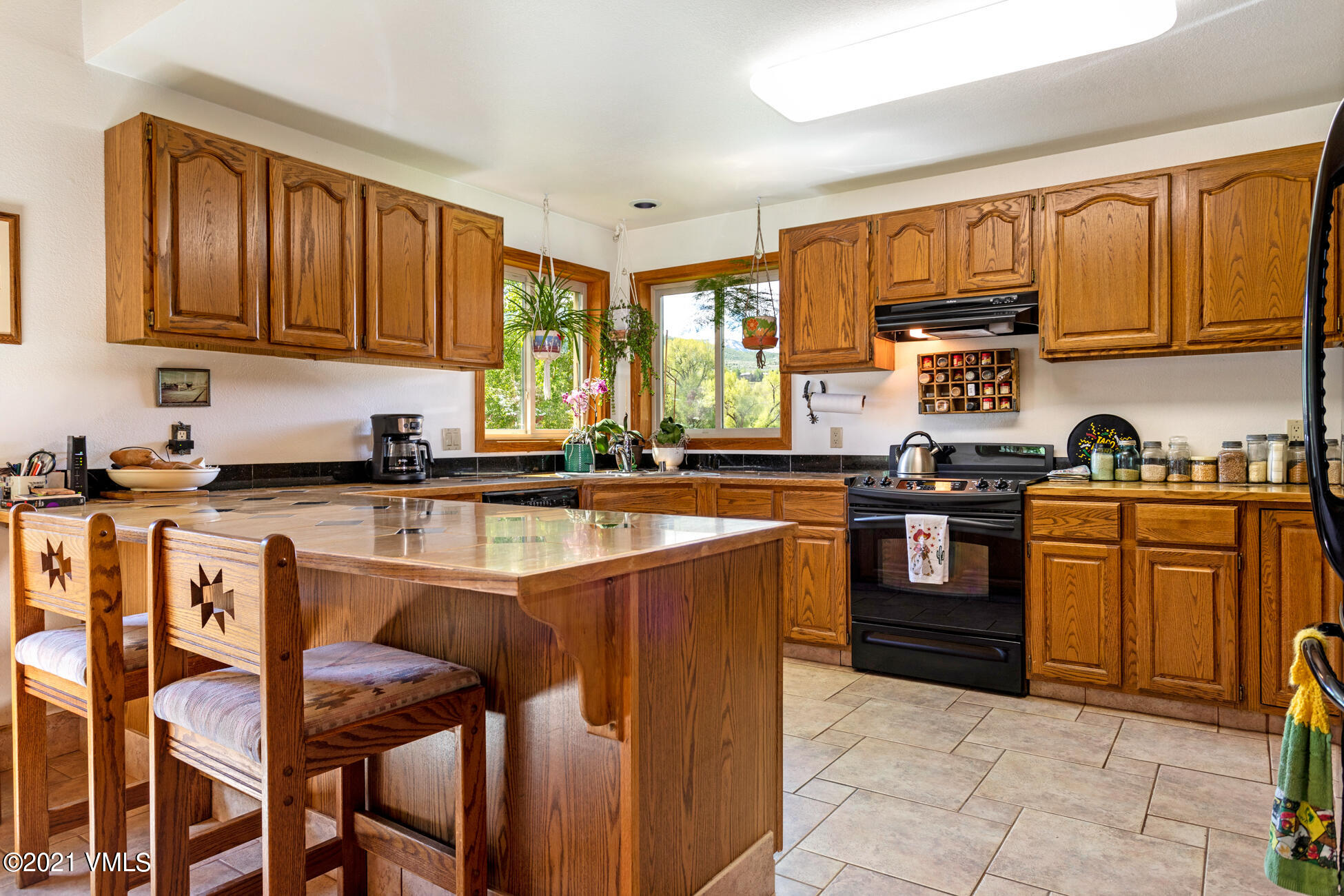 385 Edwards Access Road Edwards, CO 81632 - Photo 25 of 37 a kitchen with stainless steel appliances granite countertop a stove a sink dishwasher and a refrigerator with wooden cabinets