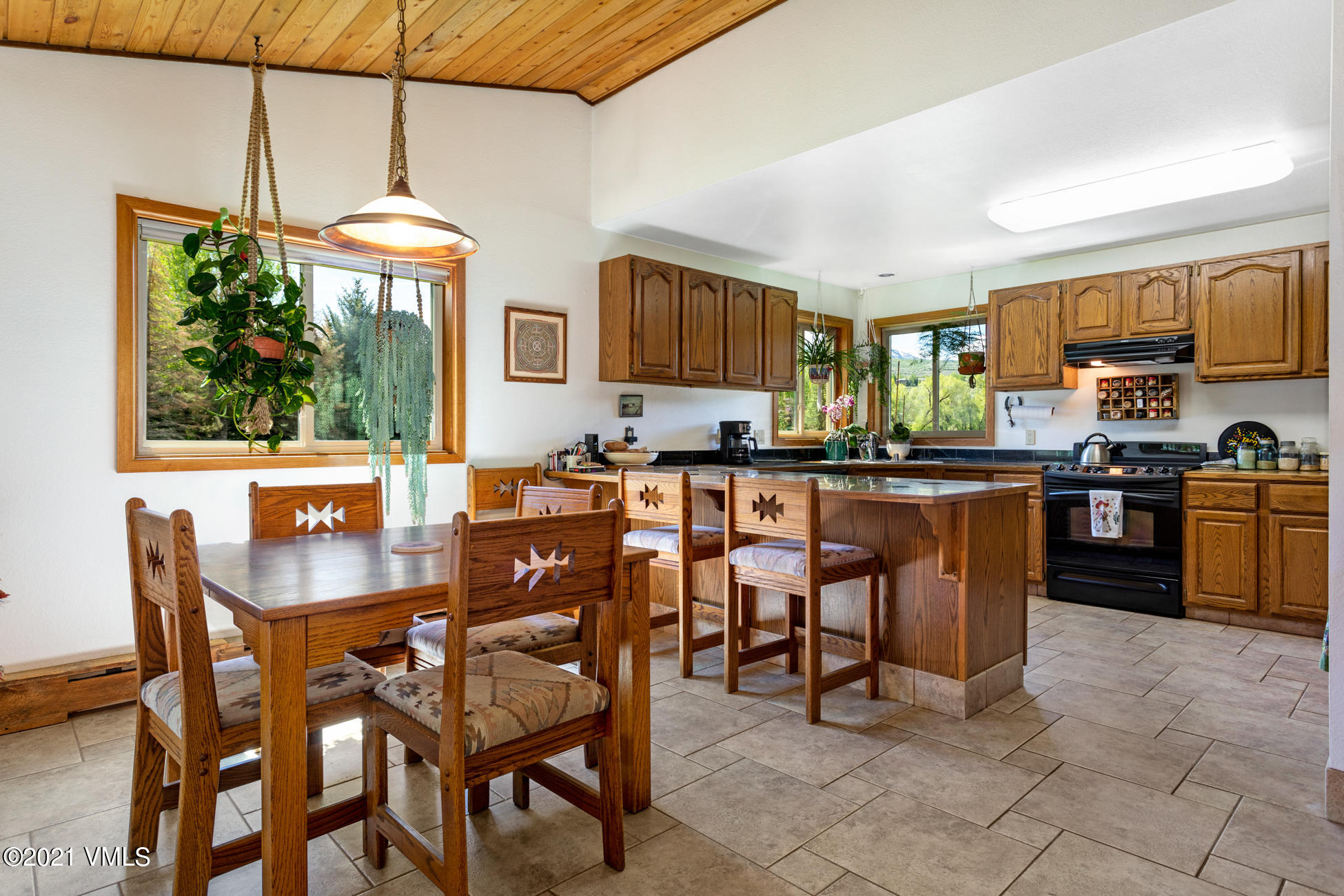 385 Edwards Access Road Edwards, CO 81632 - Photo 26 of 37 a dining room with stainless steel appliances kitchen island granite countertop a table and chairs