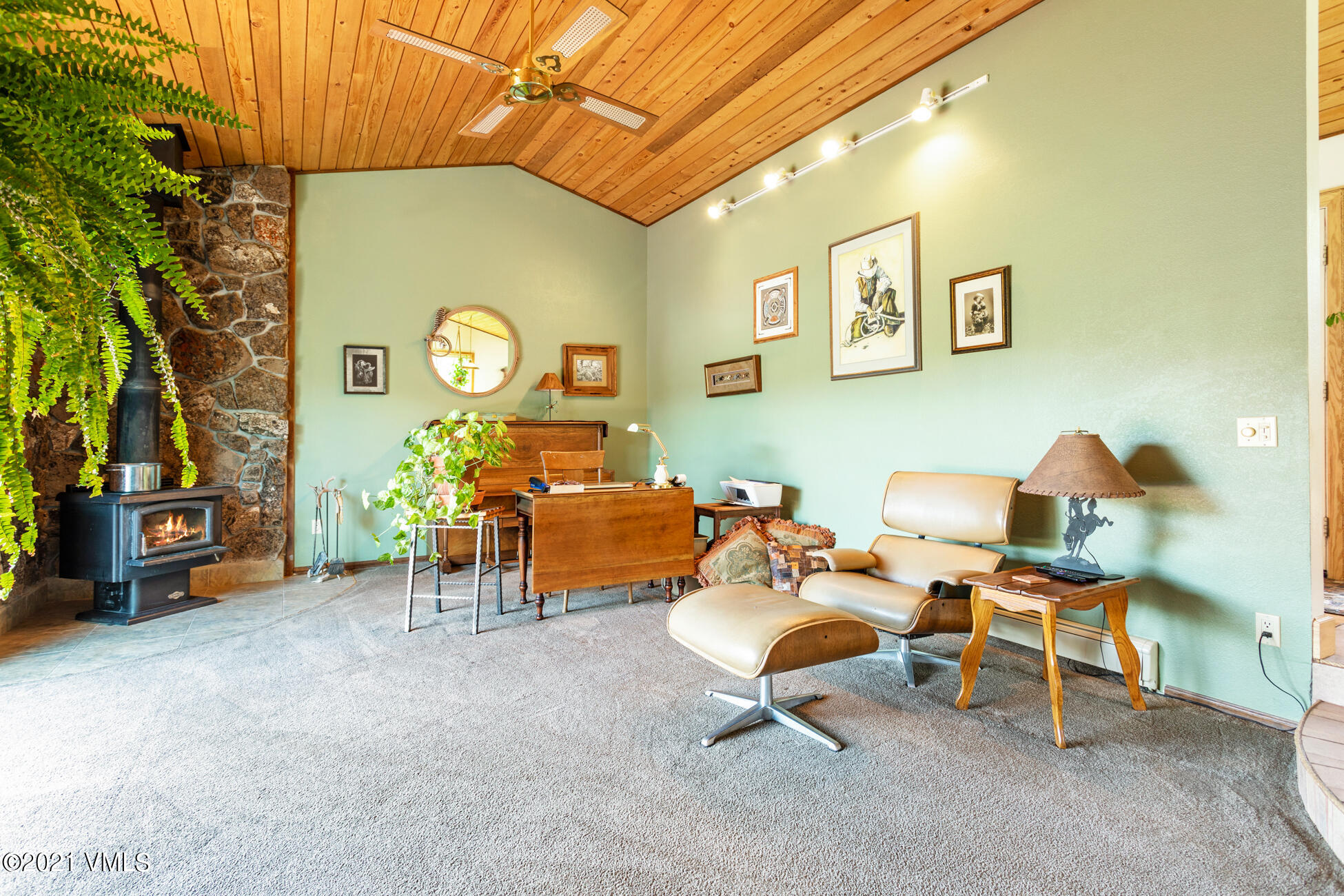 385 Edwards Access Road Edwards, CO 81632 - Photo 29 of 37 a living room with furniture and a clock