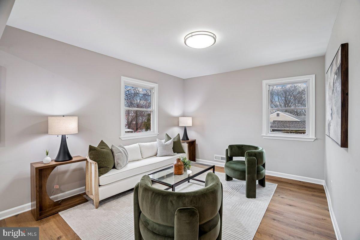 3921 Lantern Drive Silver Spring, MD 20902 - Photo 13 of 46 a living room with furniture a lamp and a window