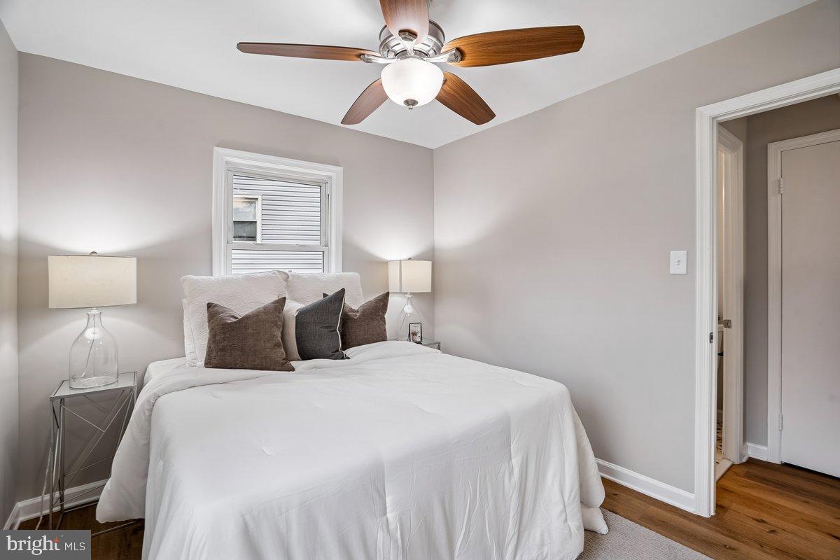 3921 Lantern Drive Silver Spring, MD 20902 - Photo 14 of 46 a bedroom with a bed and a chandelier