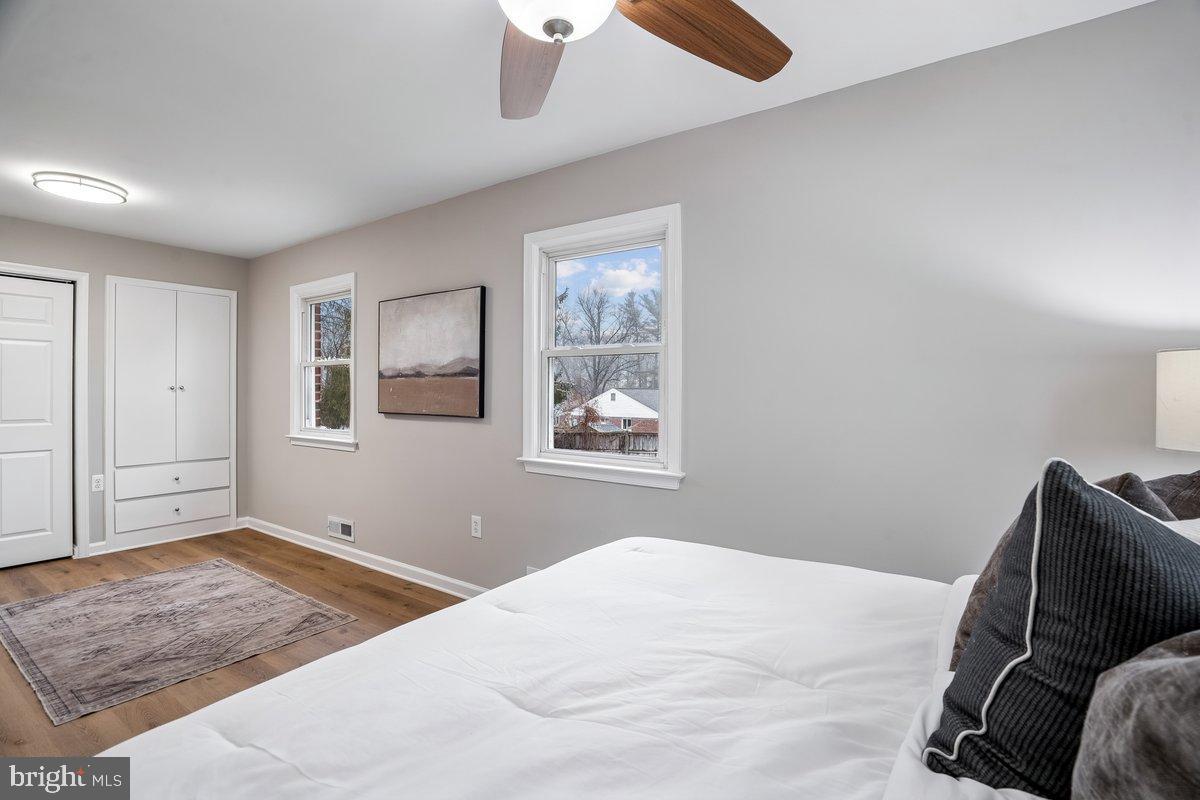 3921 Lantern Drive Silver Spring, MD 20902 - Photo 16 of 46 a bedroom with a bed and wooden floor