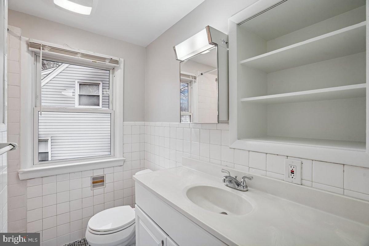 3921 Lantern Drive Silver Spring, MD 20902 - Photo 25 of 46 a bathroom with a sink toilet and mirror