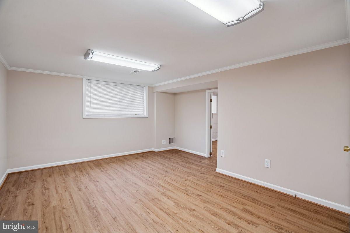 3921 Lantern Drive Silver Spring, MD 20902 - Photo 29 of 46 an empty room with wooden floor and windows