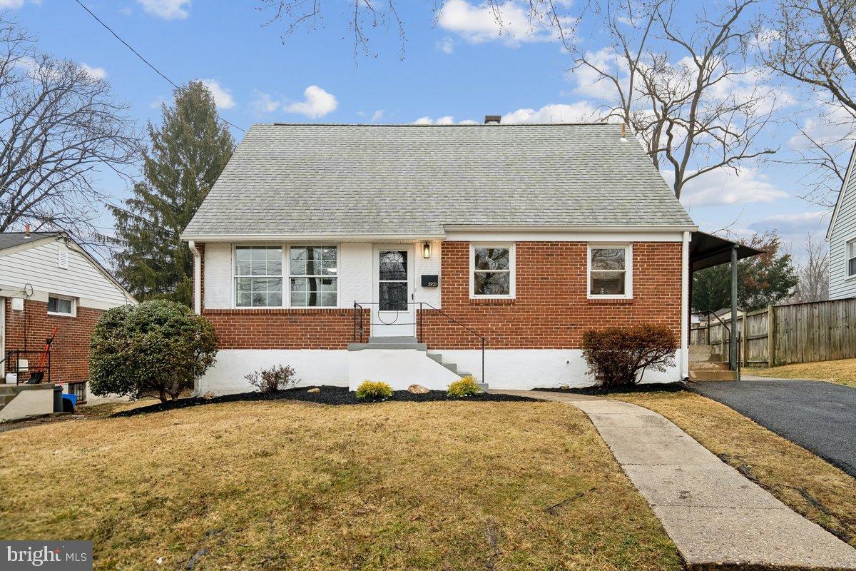 3921 Lantern Drive Silver Spring, MD 20902 - Photo 3 of 46 a front view of a house with a yard and garage