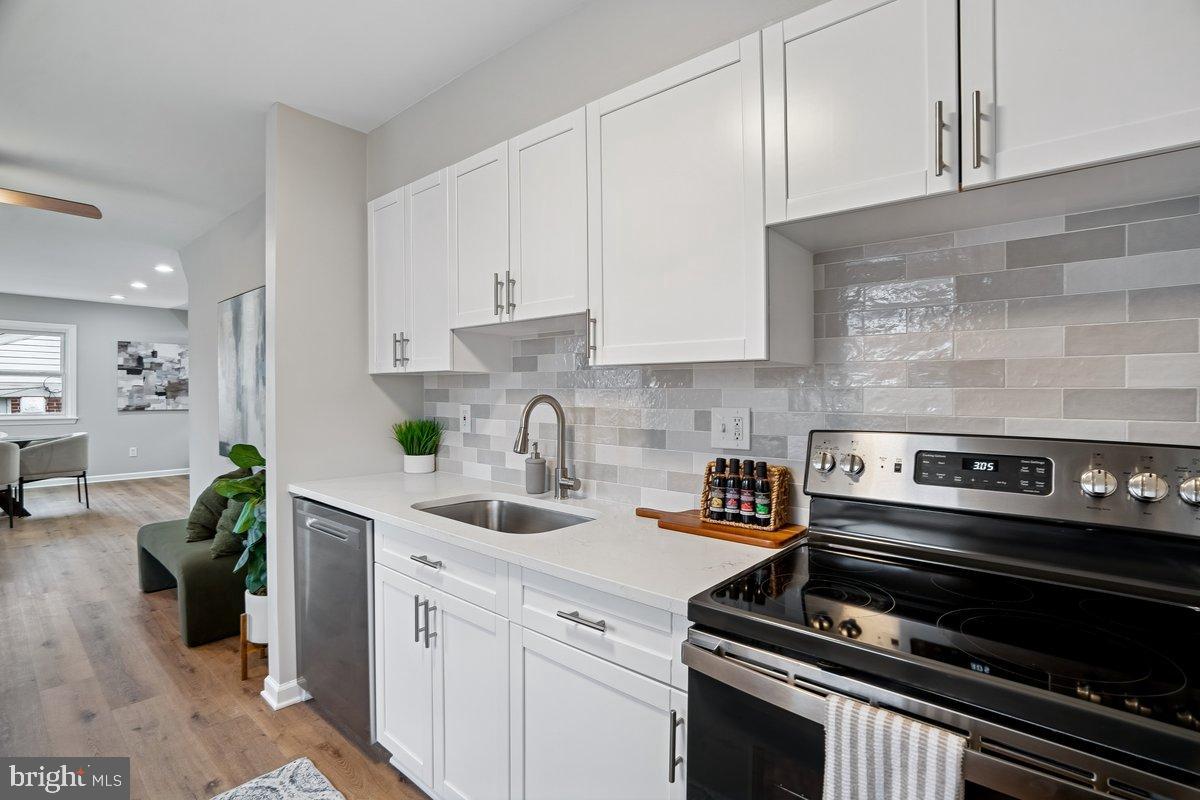 3921 Lantern Drive Silver Spring, MD 20902 - Photo 5 of 46 a kitchen with a stove a sink and cabinets
