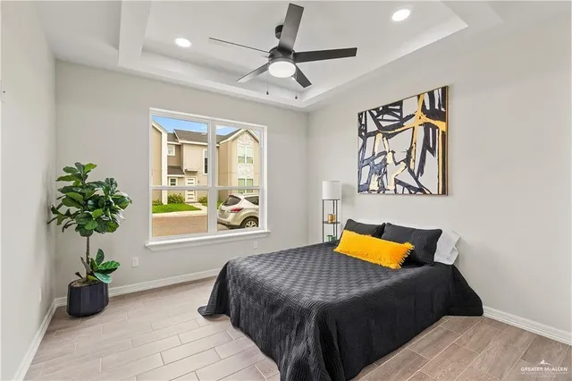 a bedroom with a bed and a chandelier