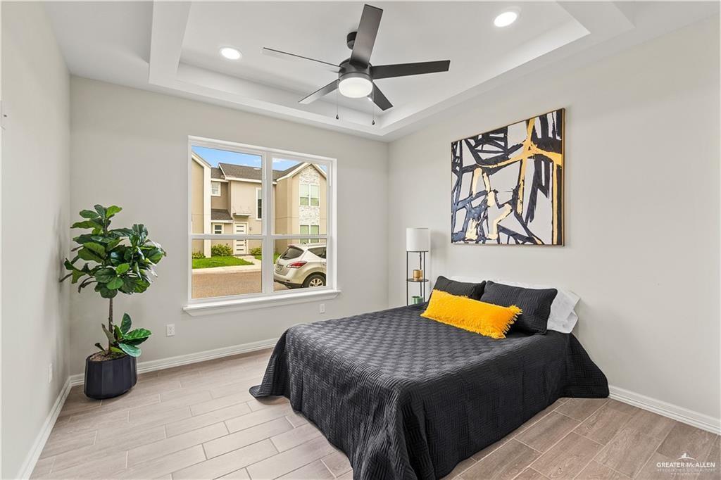 5516 North Crown Point Pharr, TX 78577 - Photo 13 of 27 a bedroom with a bed and a chandelier