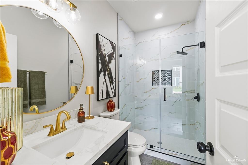 5516 North Crown Point Pharr, TX 78577 - Photo 17 of 27 a bathroom with a sink toilet and shower