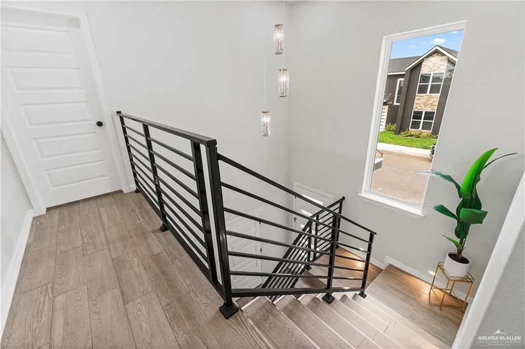 5516 North Crown Point Pharr, TX 78577 - Photo 21 of 27 a view of a hallway with wooden floor and stairs