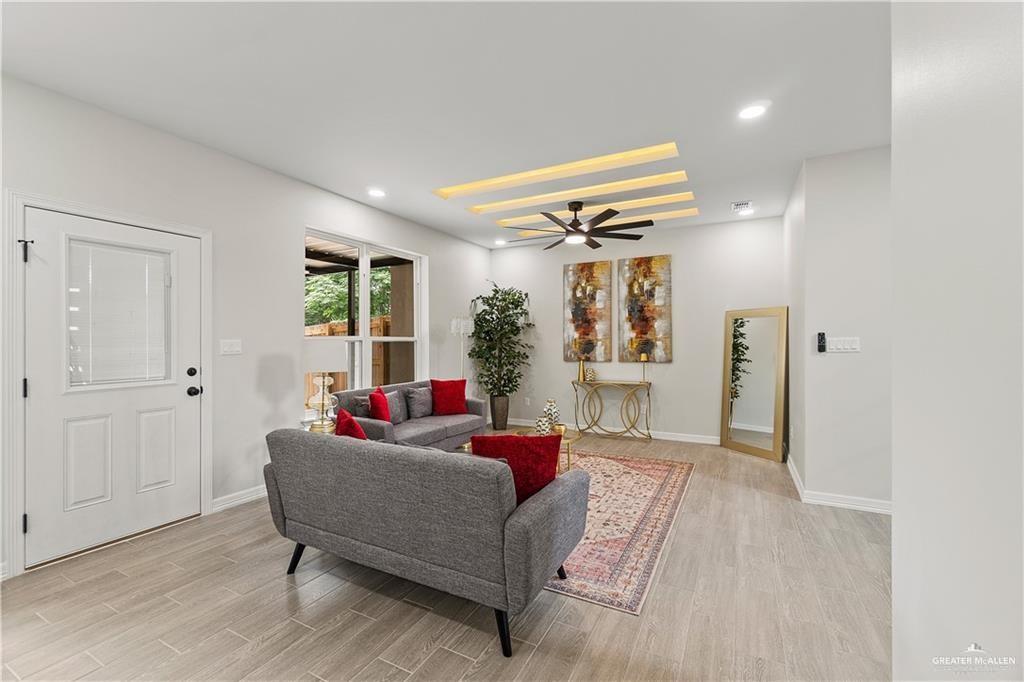 5516 North Crown Point Pharr, TX 78577 - Photo 6 of 27 a living room with furniture and a chandelier