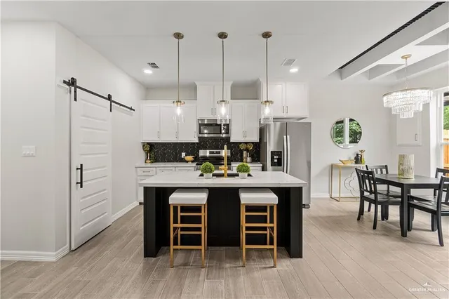 a large kitchen with a table and chairs