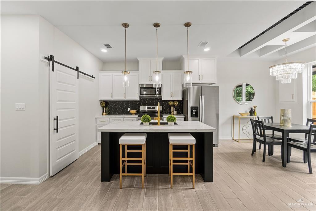 5516 North Crown Point Pharr, TX 78577 - Photo 8 of 27 a large kitchen with a table and chairs