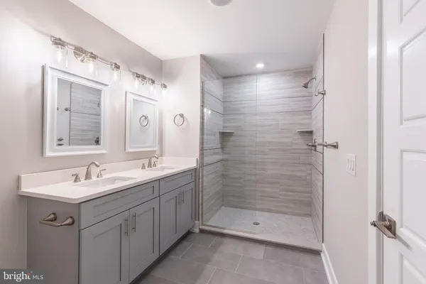 a spacious bathroom with a double vanity sink mirror and double