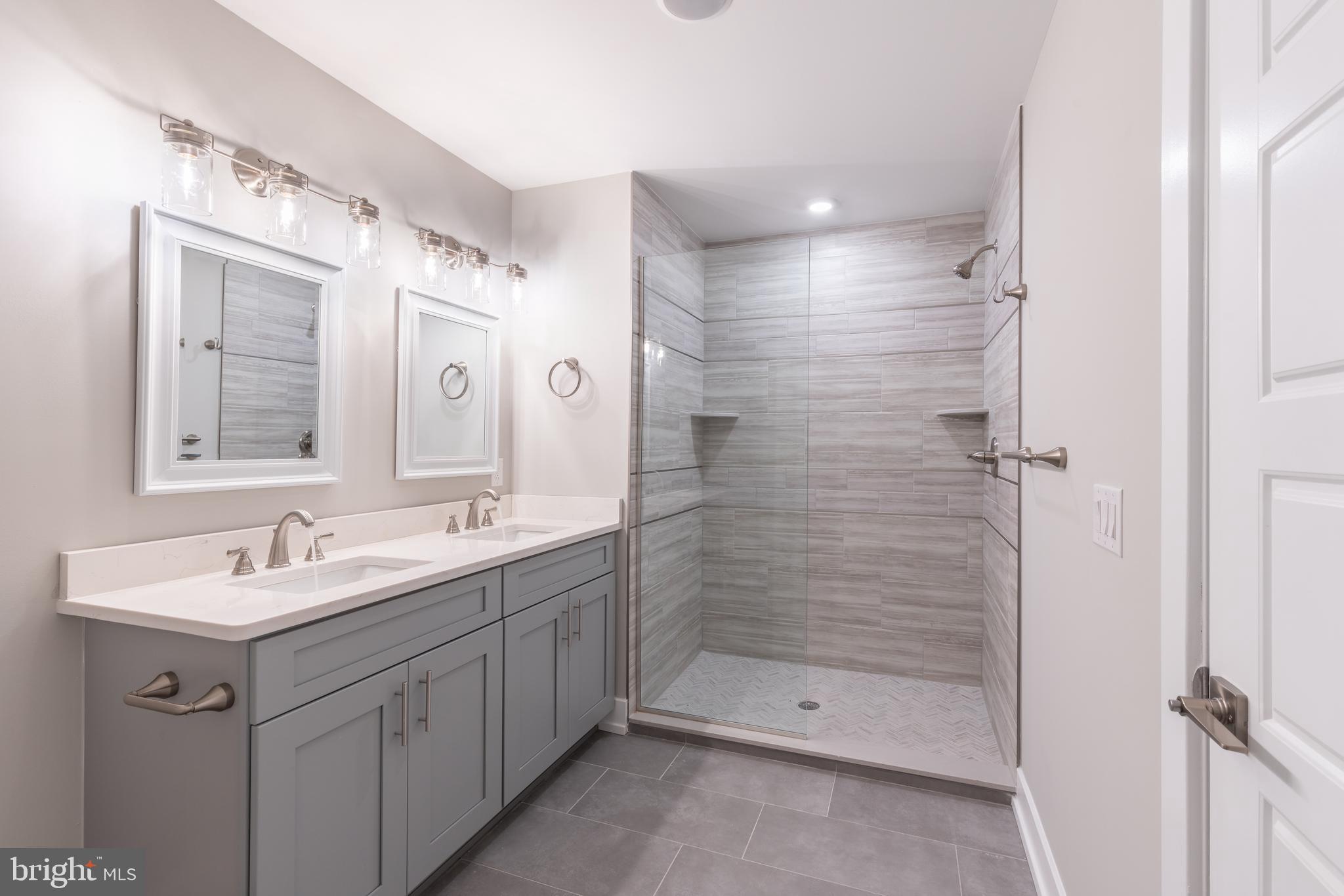2517 Hope Street, Unit 4 Philadelphia, PA 19133 - Photo 21 of 35 a bathroom with a double vanity sink mirror and shower