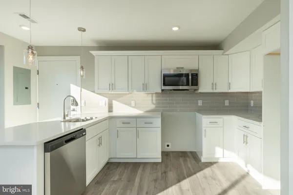 a kitchen with sink cabinets and microwave