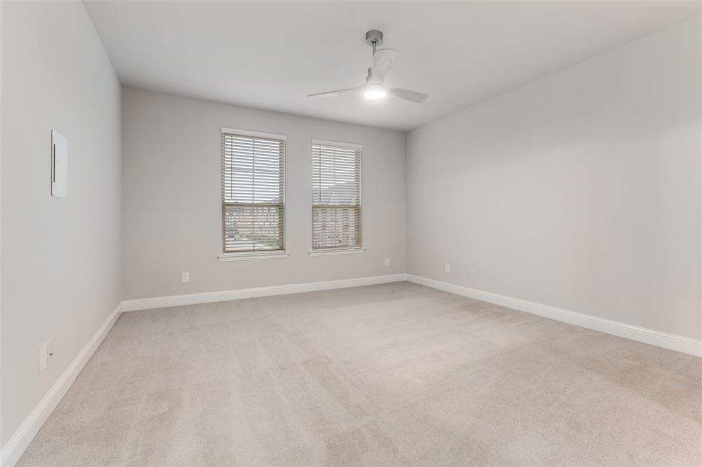 1888 Strand Street Dallas, TX 75234 - Photo 6 of 13 Spacious room featuring neutral carpeting, light gray wall paint, and white baseboards
