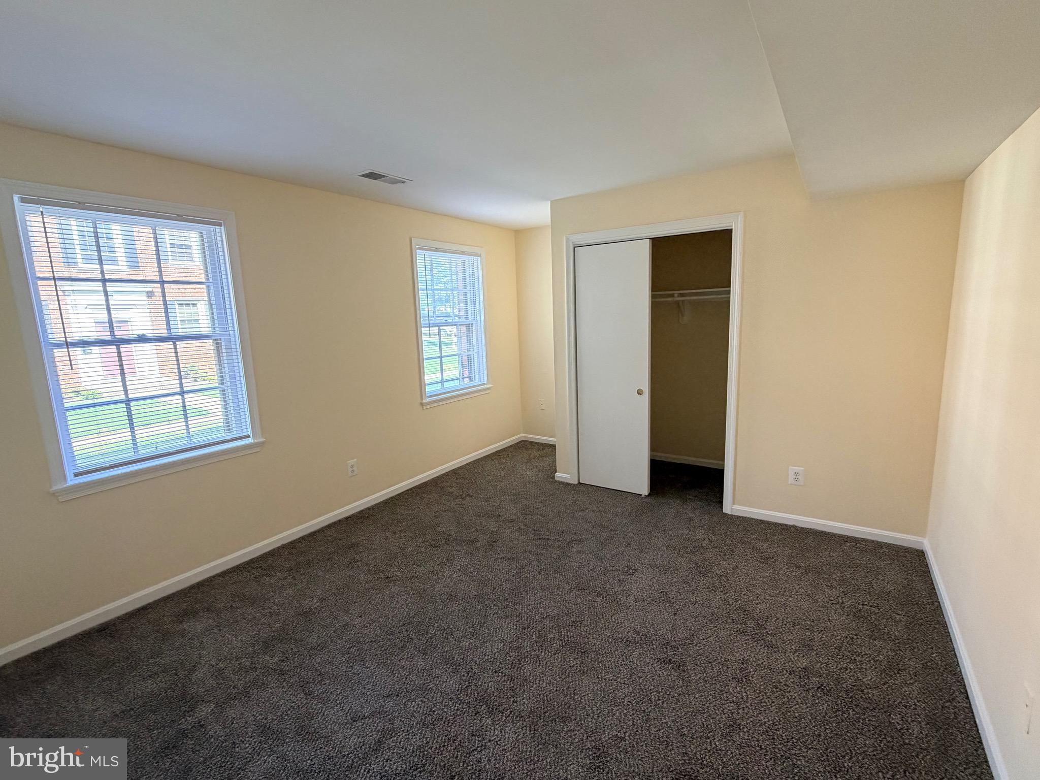 2113 Fort Davis Street Southeast, Unit 102 Washington, DC 20020 - Photo 5 of 9 an empty room with windows