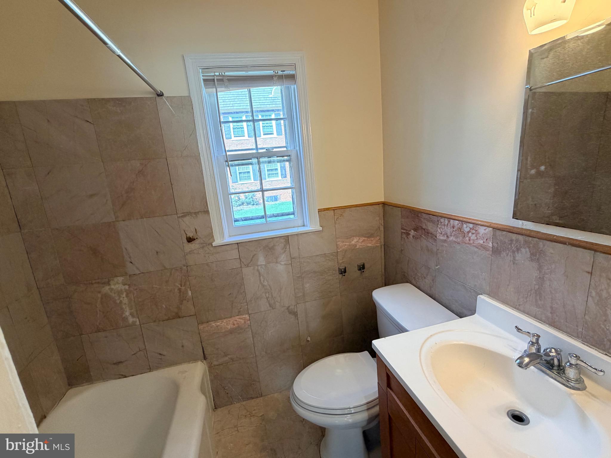 2113 Fort Davis Street Southeast, Unit 102 Washington, DC 20020 - Photo 7 of 9 a bathroom with a sink toilet and shower
