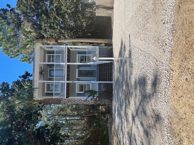 47 15th Street Santa Rosa Beach, FL 32459 - Photo 2 of 20 a front view of a house with a yard and garage