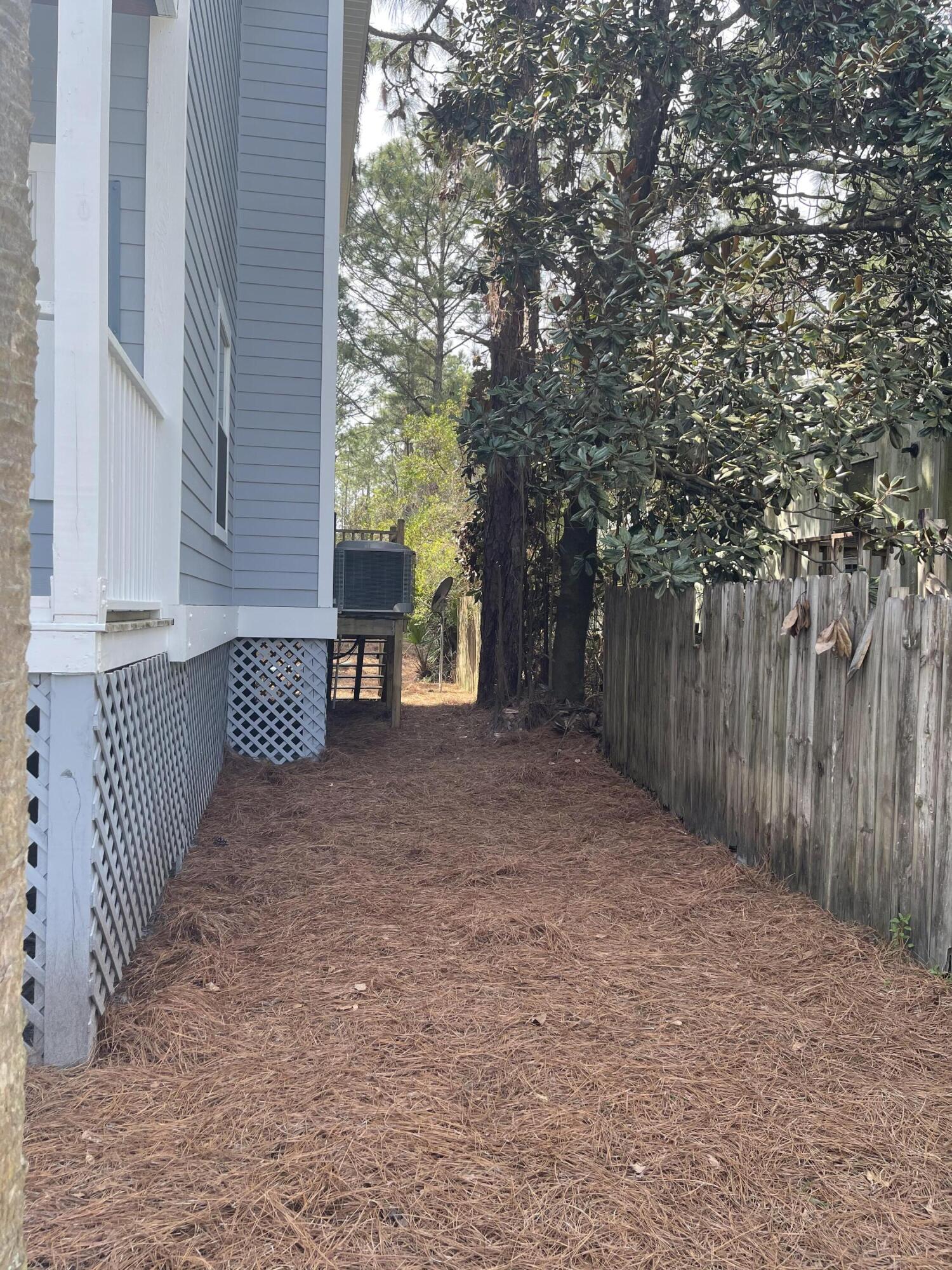 47 15th Street Santa Rosa Beach, FL 32459 - Photo 17 of 20 a view of a house with a backyard and trees