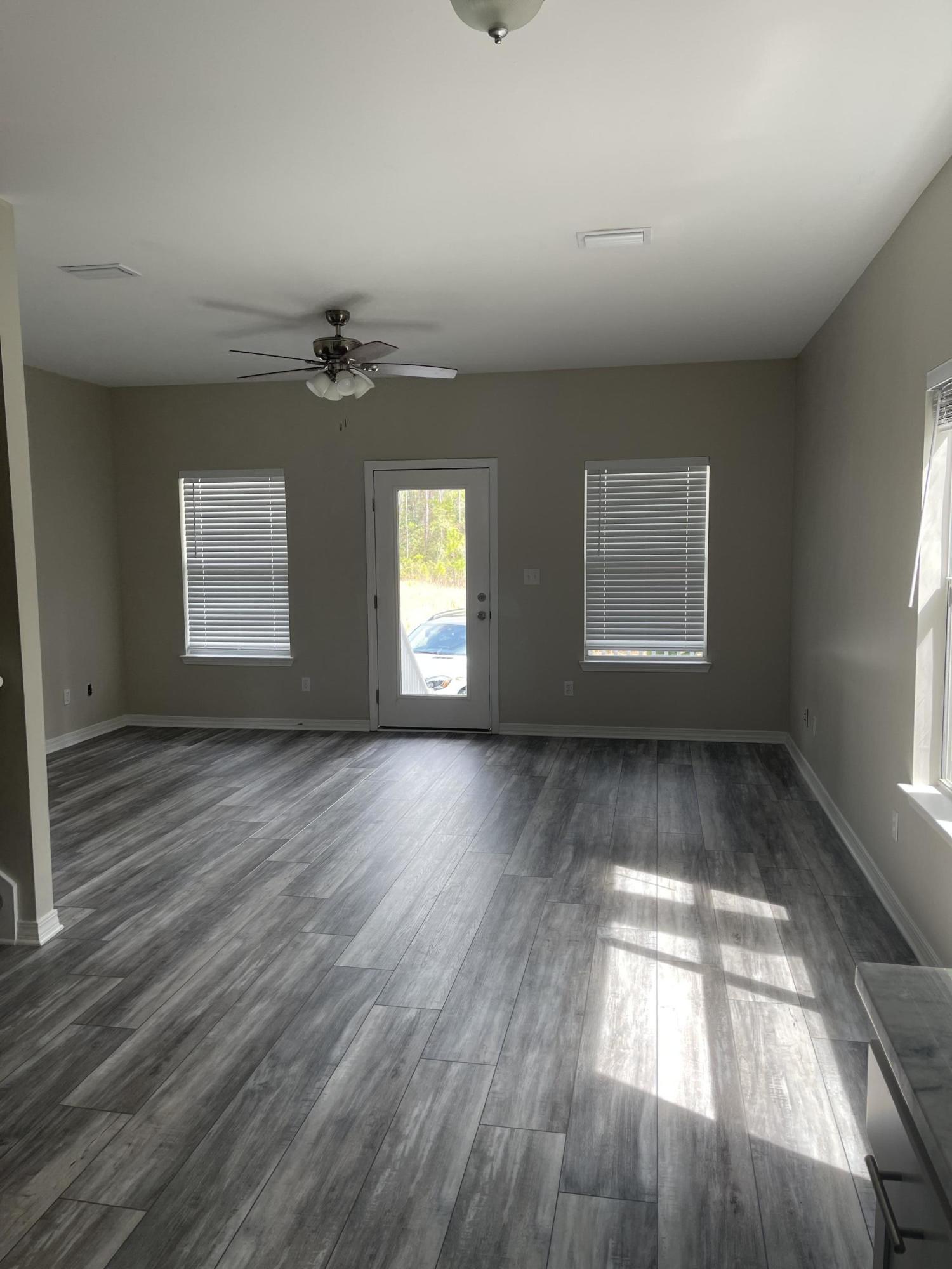 47 15th Street Santa Rosa Beach, FL 32459 - Photo 5 of 20 wooden floor in an empty room with a window