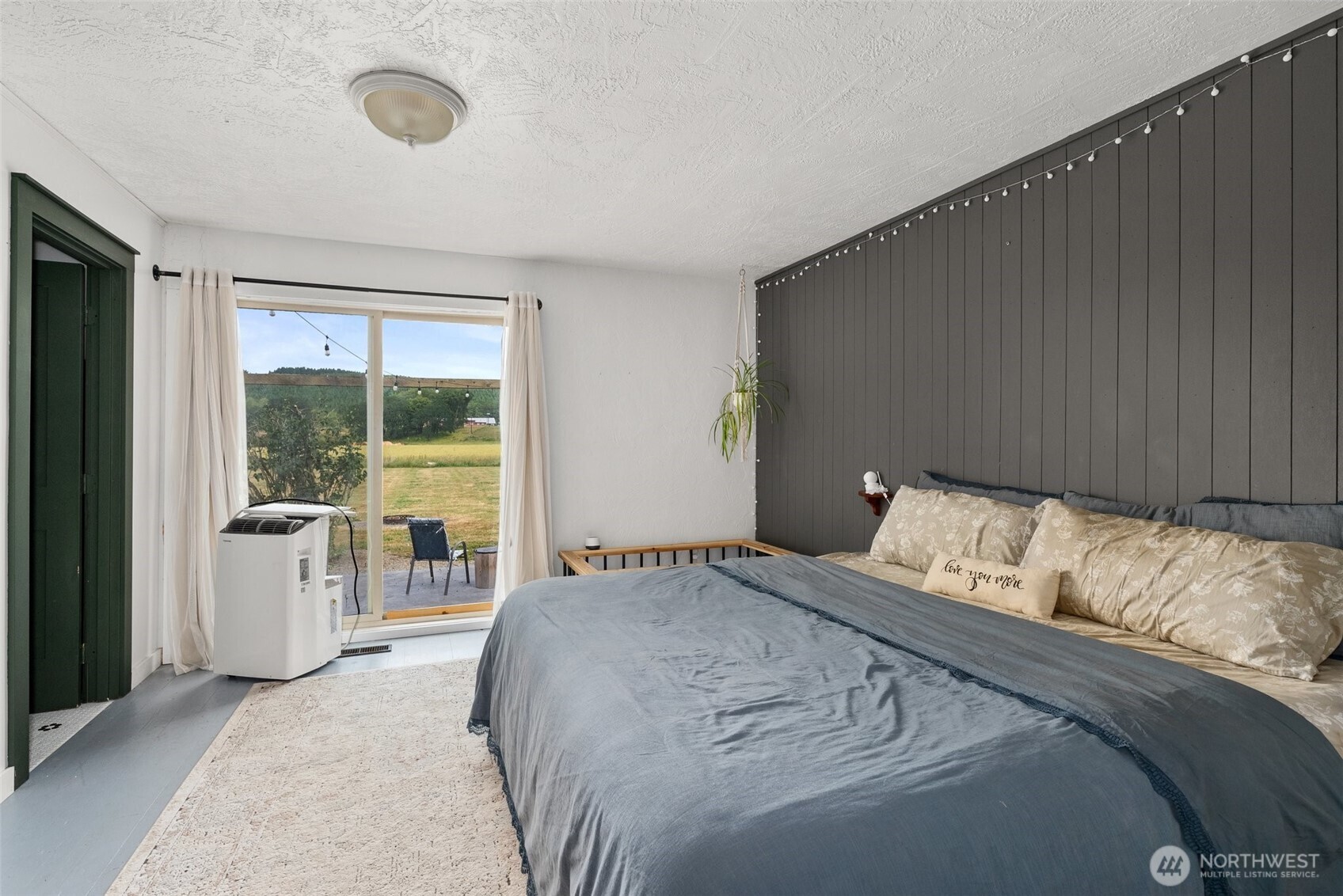 953 Boistfort Road Curtis, WA 98538 - Photo 13 of 40 a bedroom with a large bed and a large window