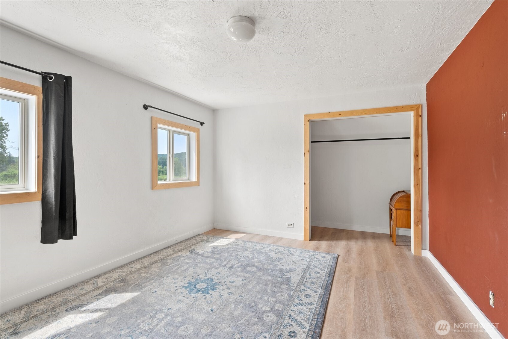 953 Boistfort Road Curtis, WA 98538 - Photo 22 of 40 a view of an empty room with wooden floor and a window