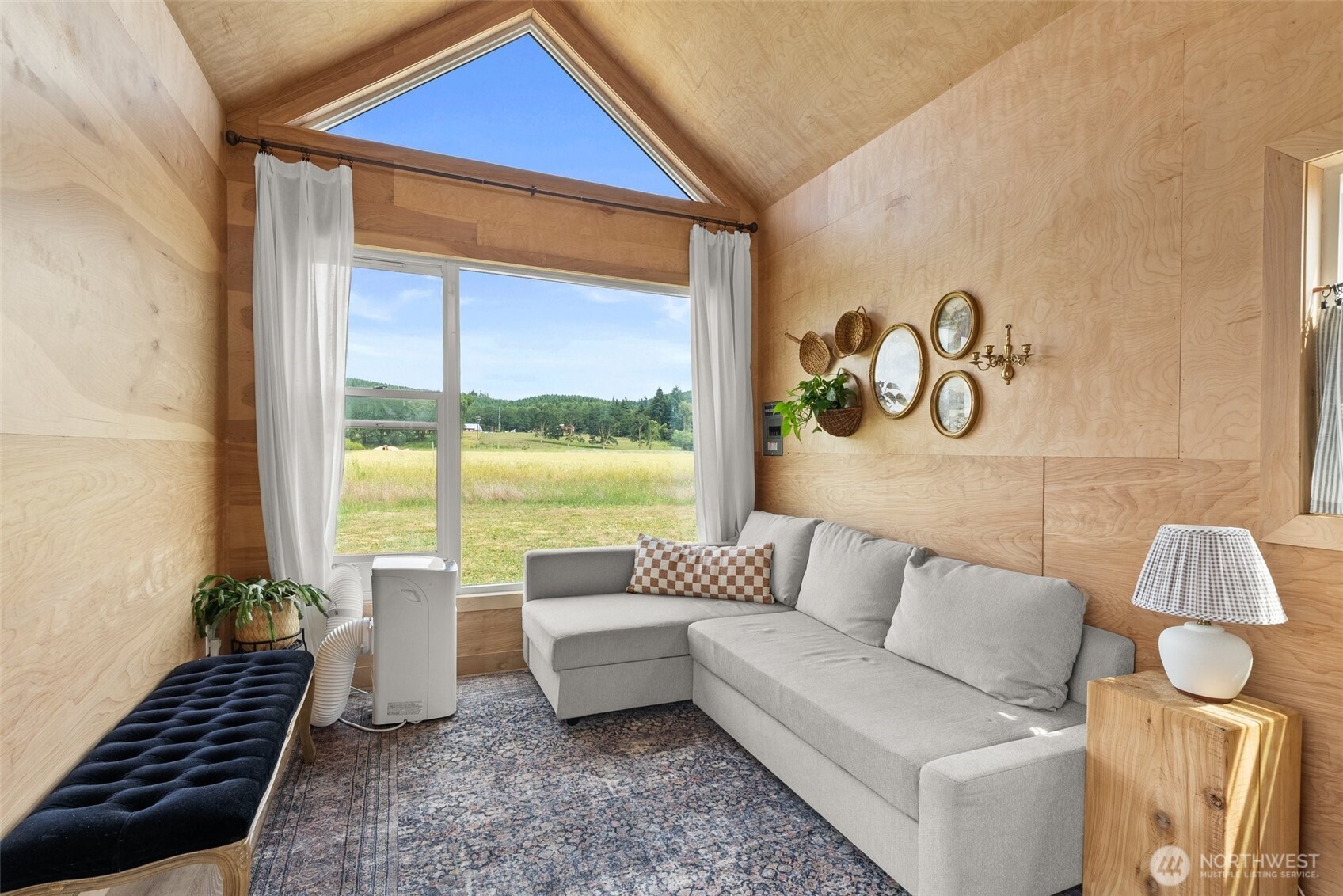 953 Boistfort Road Curtis, WA 98538 - Photo 34 of 40 a living room with furniture and a floor to ceiling window
