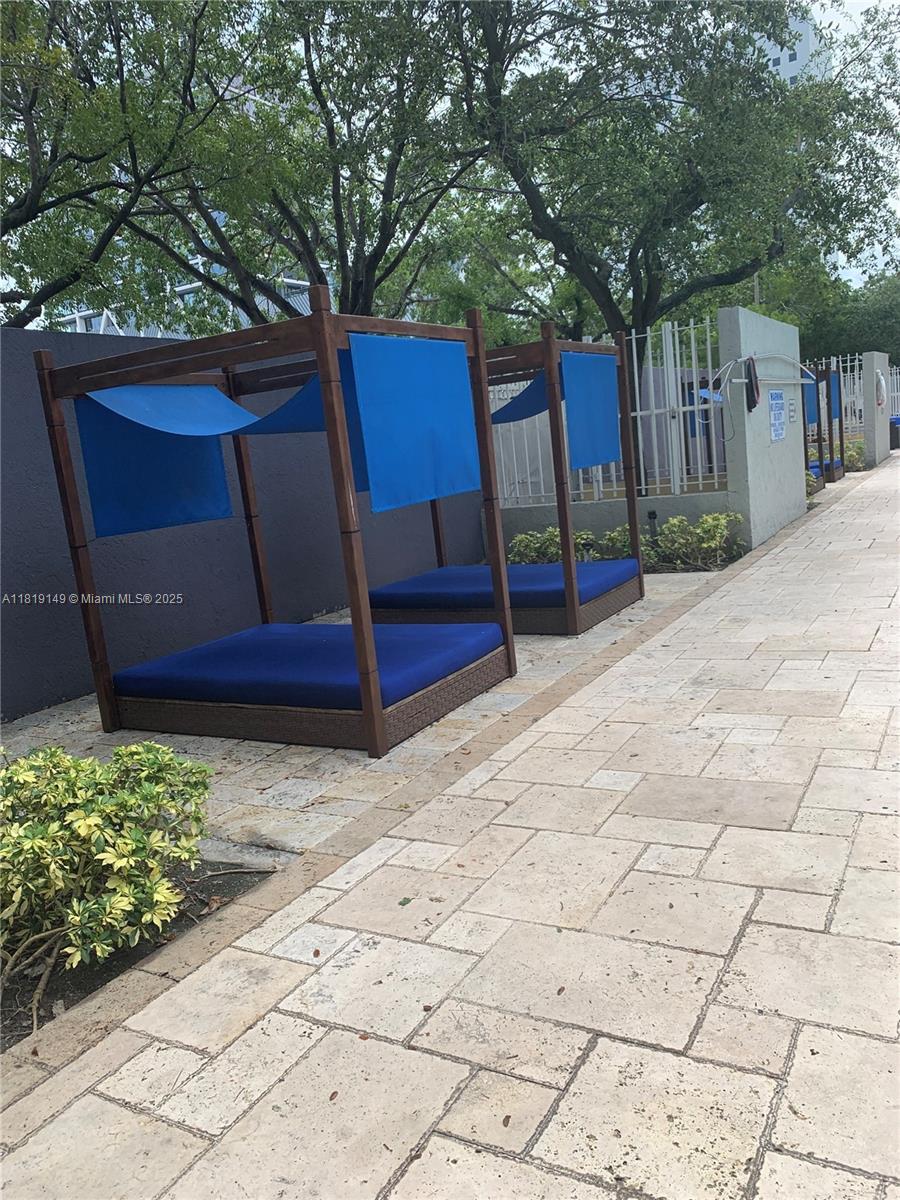 850 North Miami Avenue, Unit W1001 Miami, FL 33136 - Photo 18 of 30 a wooden bench sitting in front of a building