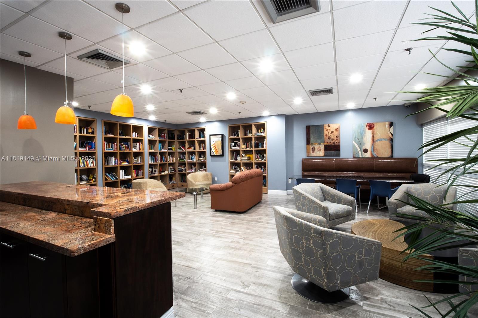 850 North Miami Avenue, Unit W1001 Miami, FL 33136 - Photo 21 of 30 a living room with furniture a dining table and a bookshelf with wooden floor