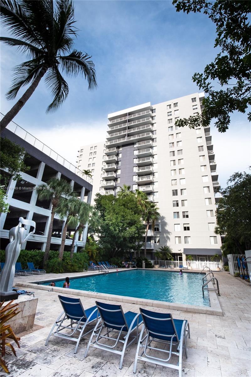 850 North Miami Avenue, Unit W1001 Miami, FL 33136 - Photo 26 of 30 a view of a patio with table and chairs and potted plants