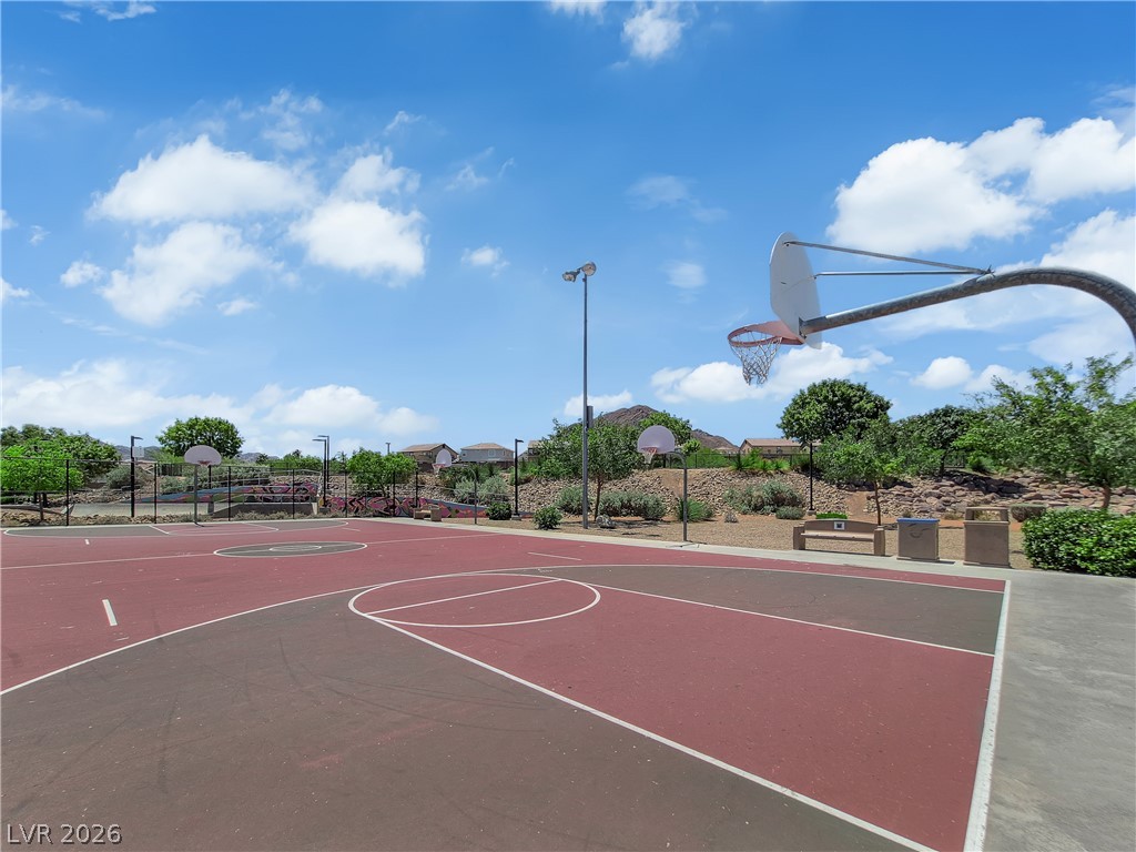 646 Monument Point Street Henderson, NV 89002 - Photo 41 of 44 An inviting outdoor basketball court awaits active recreation under a vast blue sky.