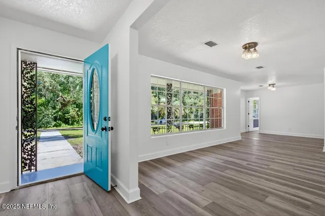 a view of bathroom with bathtub and windows