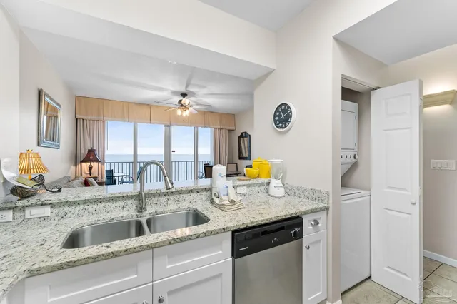 a kitchen with a sink a refrigerator and a stove top oven