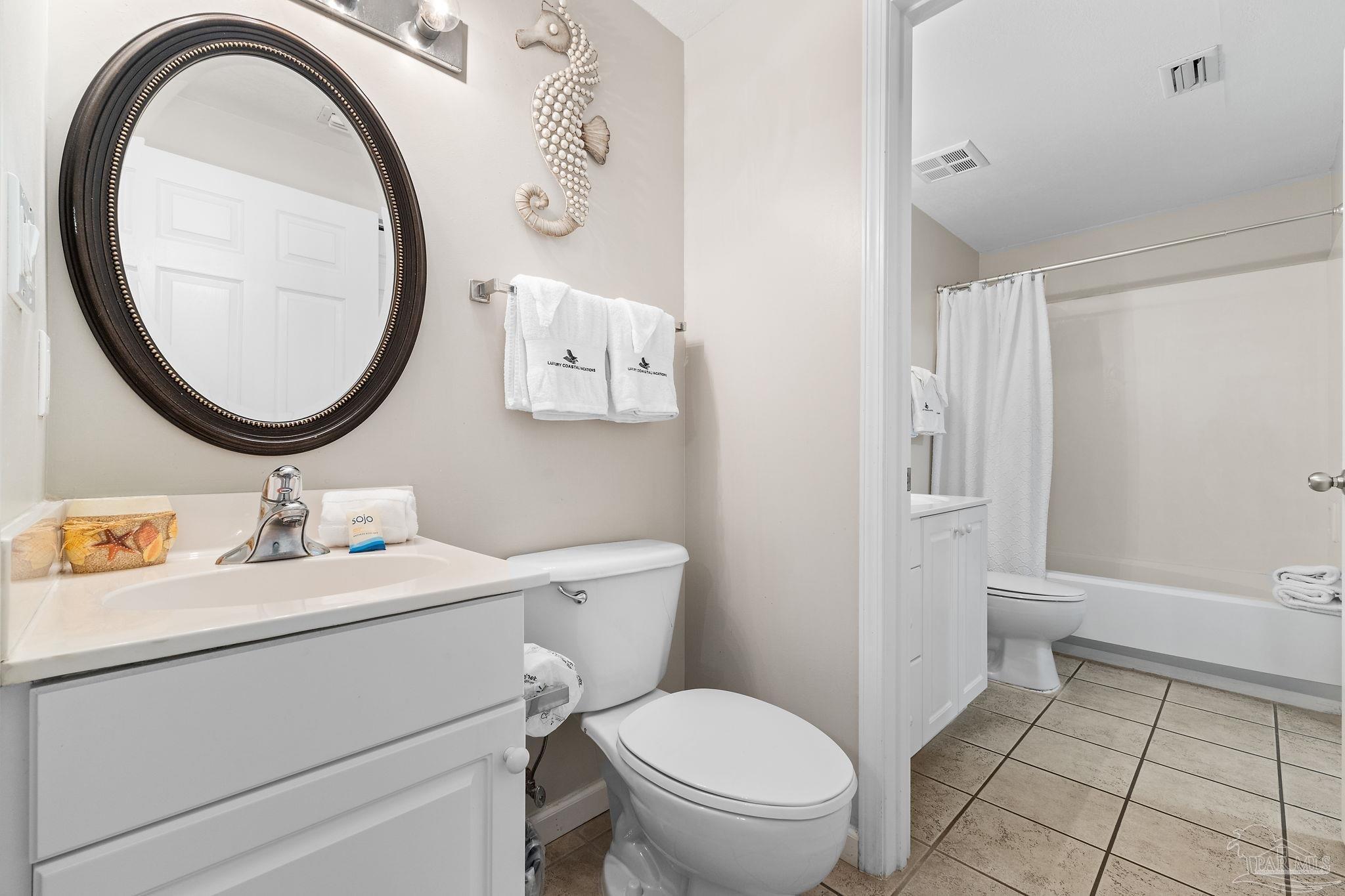 14511 Perdido Key Drive, Unit 904 Perdido Key, FL 32507 - Photo 25 of 64 a bathroom with a toilet a sink and a mirror