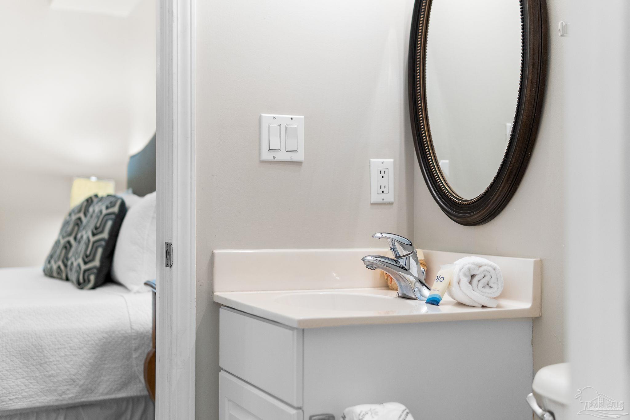 14511 Perdido Key Drive, Unit 904 Perdido Key, FL 32507 - Photo 26 of 64 a bathroom with a sink a mirror and toilet