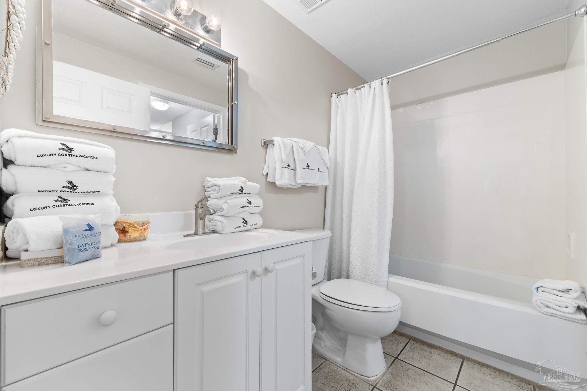 14511 Perdido Key Drive, Unit 904 Perdido Key, FL 32507 - Photo 27 of 64 a bathroom with a sink a toilet and a mirror