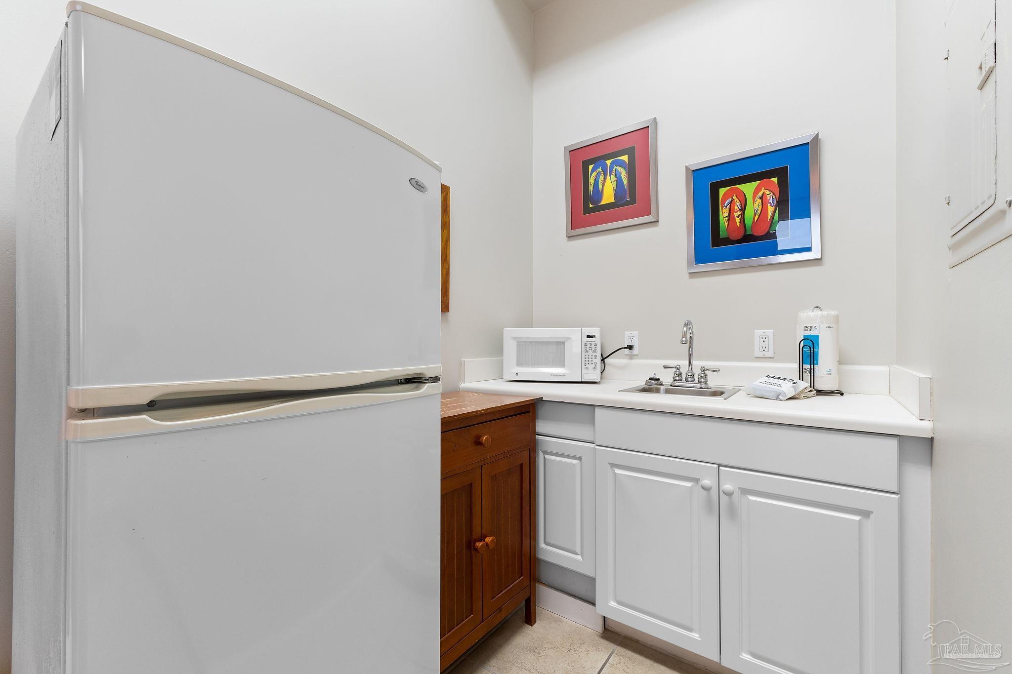 14511 Perdido Key Drive, Unit 904 Perdido Key, FL 32507 - Photo 37 of 64 a utility room with cabinets washer and dryer