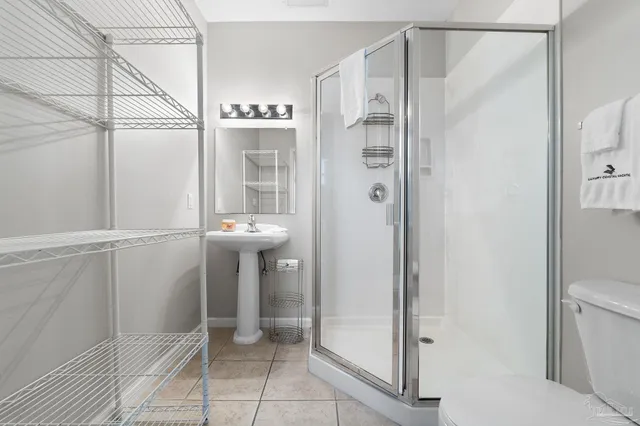 a view of a patio with a table chairs and a floor to ceiling window